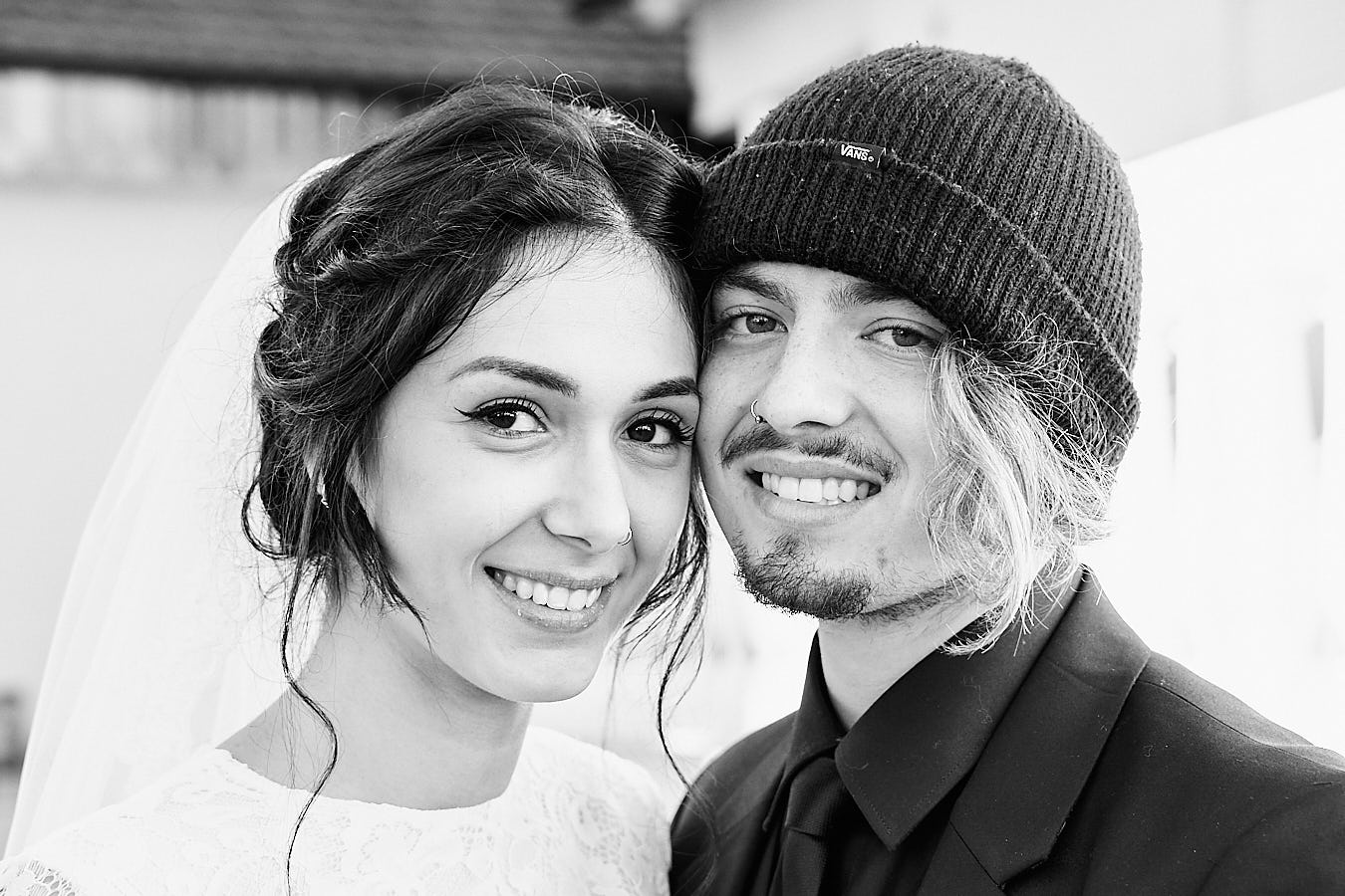 young couple. both looking straight into the camera. they are happy. they just got married. picture is in black and white